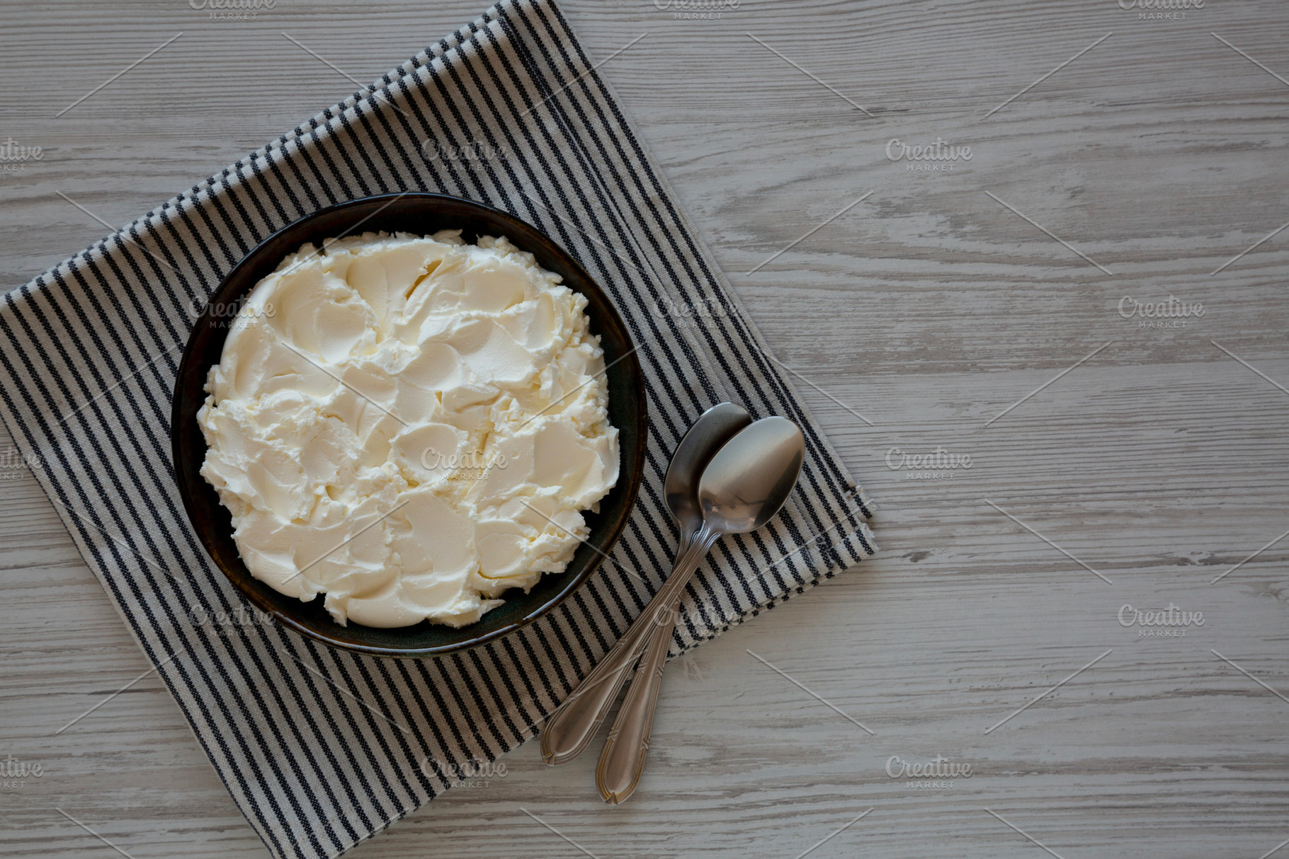 Organic White Mascarpone Cheese in a Bowl, top view. Copy space., a Food & Drink Photo by LiudmylaChuhunova