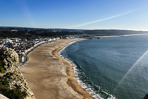 Panoramic view of Nazare beachfront and coastline under sunny sky, Portugal, a Photo by AS photostudio