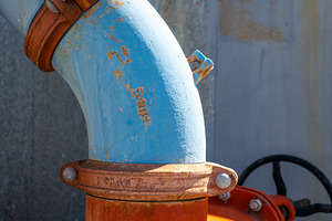 Rusty industrial water pipes with valves and connectors in an ur, a Photo by GoodGoods