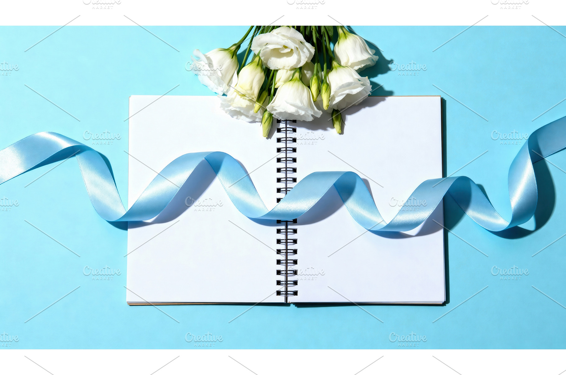 Open notebook with white flowers and, a Background Photo by tilialucida