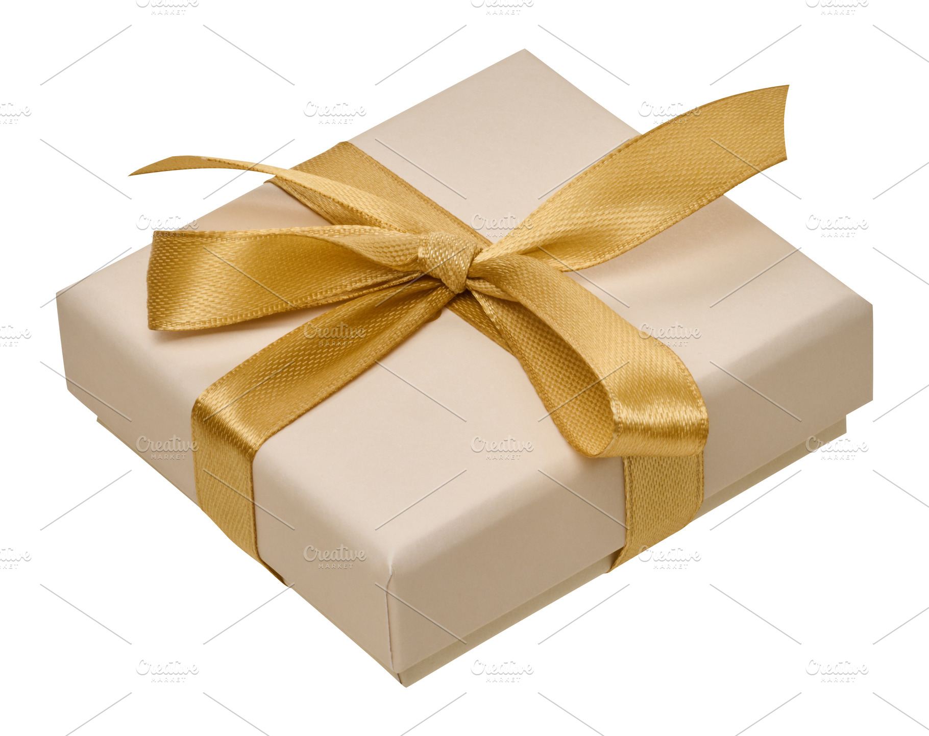 Beige gift box with golden satin ribbon on isolated background, a Holiday Photo by ndanko