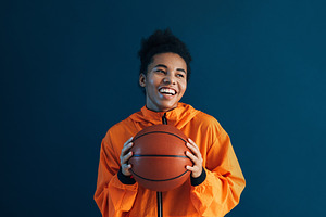 Portrait of a happy woman in orange, a Sports & Recreation Photo by Artem Varnitsin