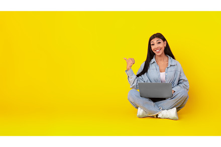 Happy lady using laptop pointing, a Person Photo by Prostock-Studio