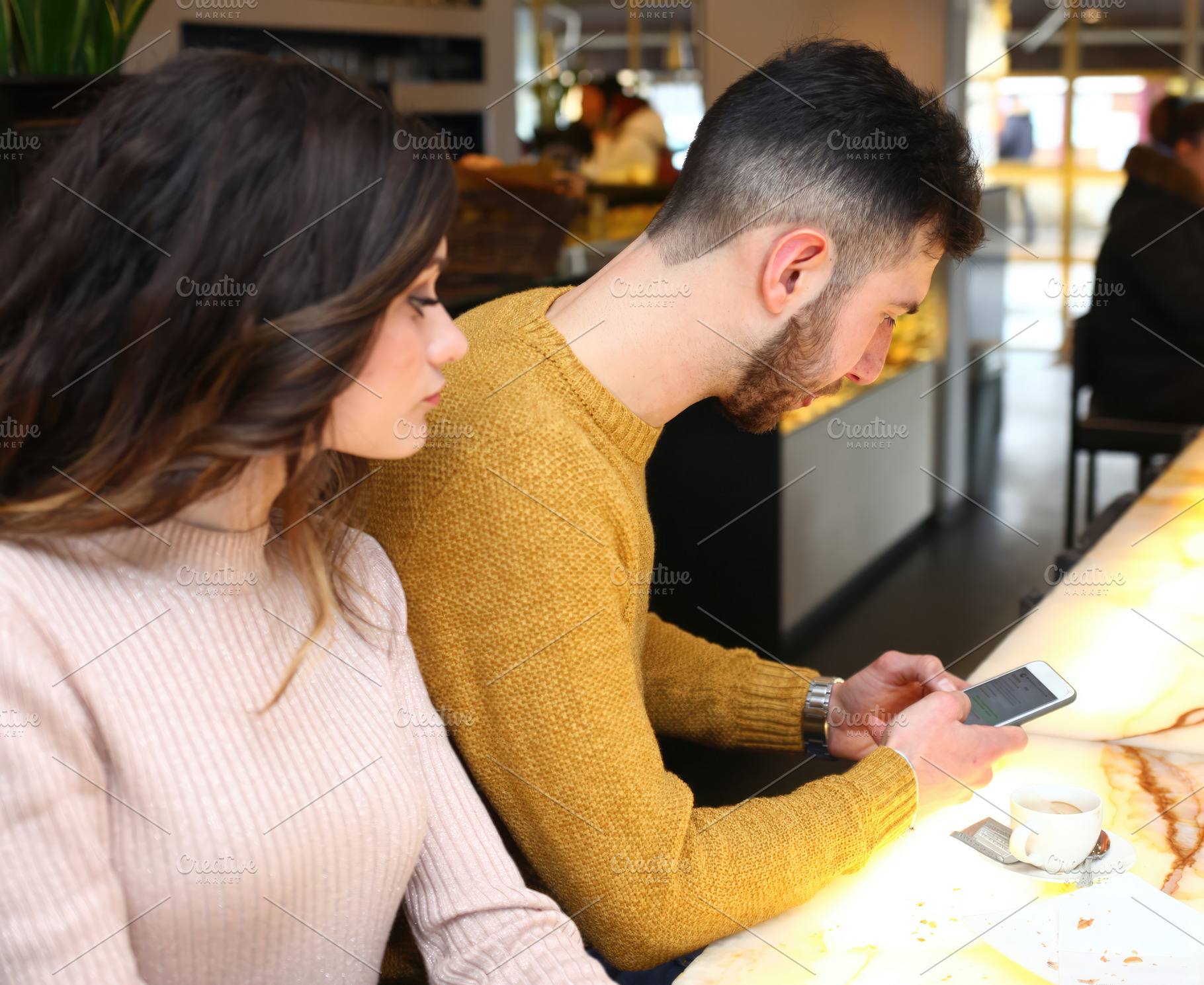 Jealous girlfriend checking boyfriend's phone in a cafe, an Abstract Photo by Antonio Gravante Market