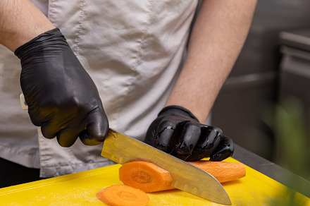 Chef slicing fresh carrot, a Photo by Grafvision photography