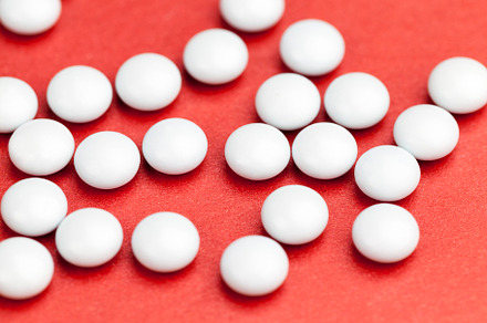 medicines for the treatment of diseases scattered on a red background, a Background Photo by MyPhotos