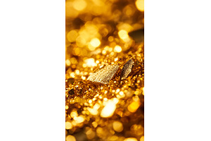 Close up of shimmering gold nuggets, a Business Photo by Lermont51