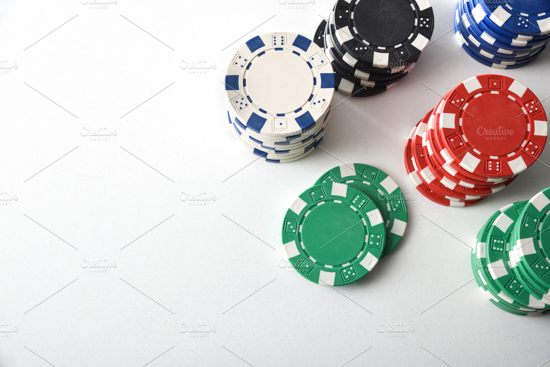 Stacks of colorful casino chips on white isolated table, an Arts & Entertainment Photo by Davizro's Market