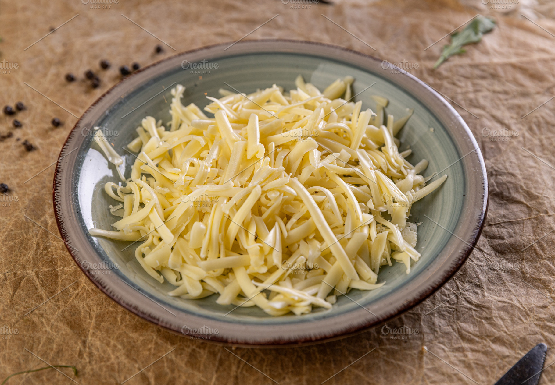 Shredded cheese filling a plate, a Photo by Grafvision photography