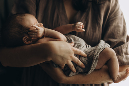 Happy Mothers day! Mother hugging cute little newborn baby close