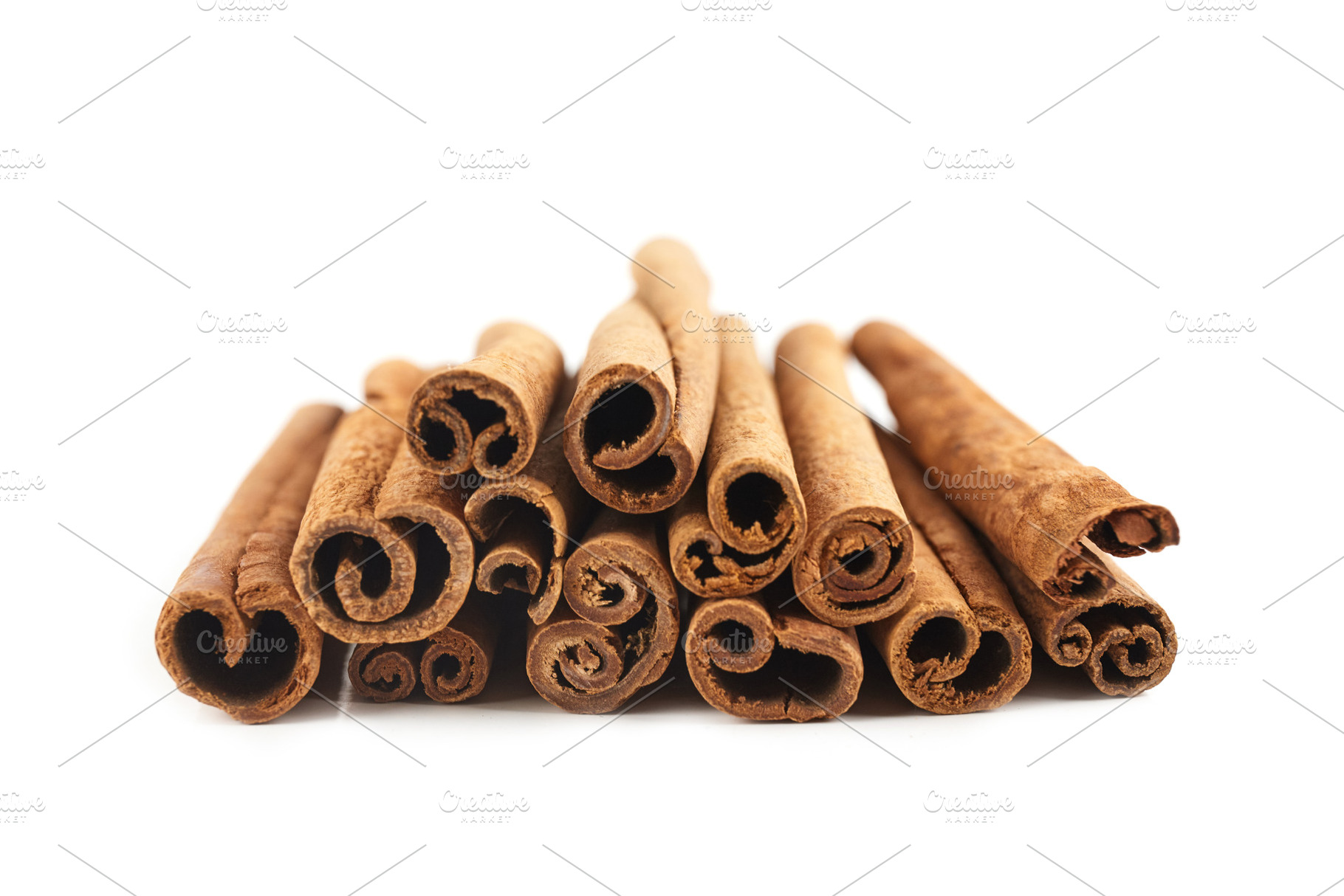 Cinnamon sticks isolated on white ba, a Background Photo by OleksandrRybitskyi