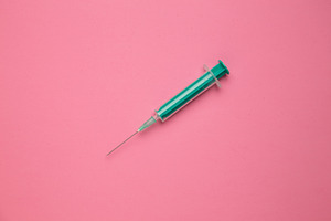 Medical syringe on colorful backgrou