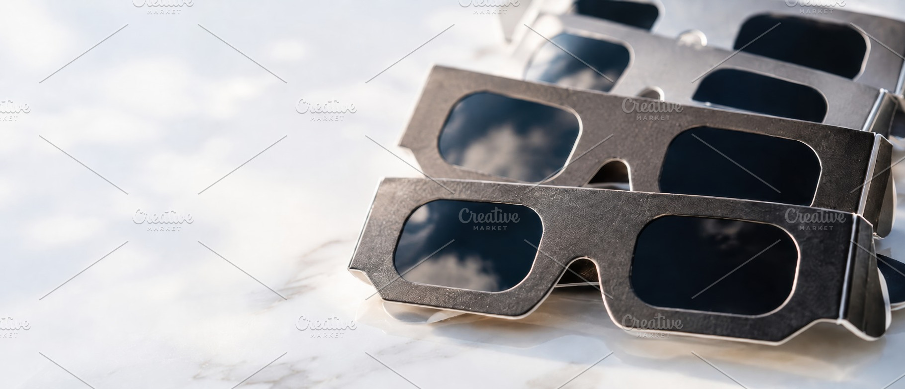 Solar eclipse viewing glasses on whi, a Photo by Dvoevnore photos