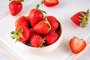 Fresh raw red strawberry on white marble background, a Food & Drink Photo by Rimma