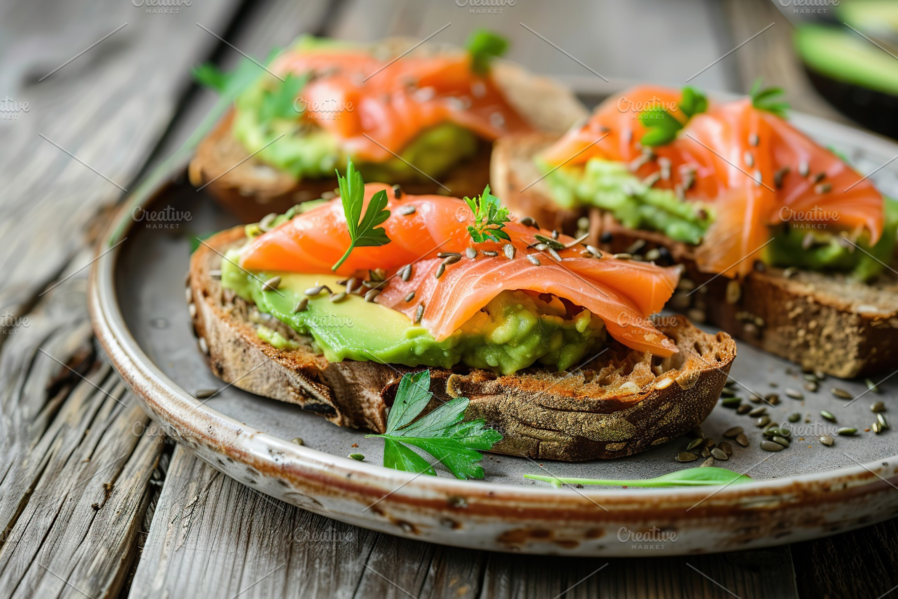Toast bread with salted salmon and guacamole avocado on wooden table, a Food & Drink Photo by AlyaAnd