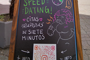 Signboard on a sidewalk promoting a speed dating event, an Arts & Entertainment Photo by DanFLCreativo