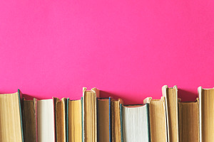 Old books on a pink background