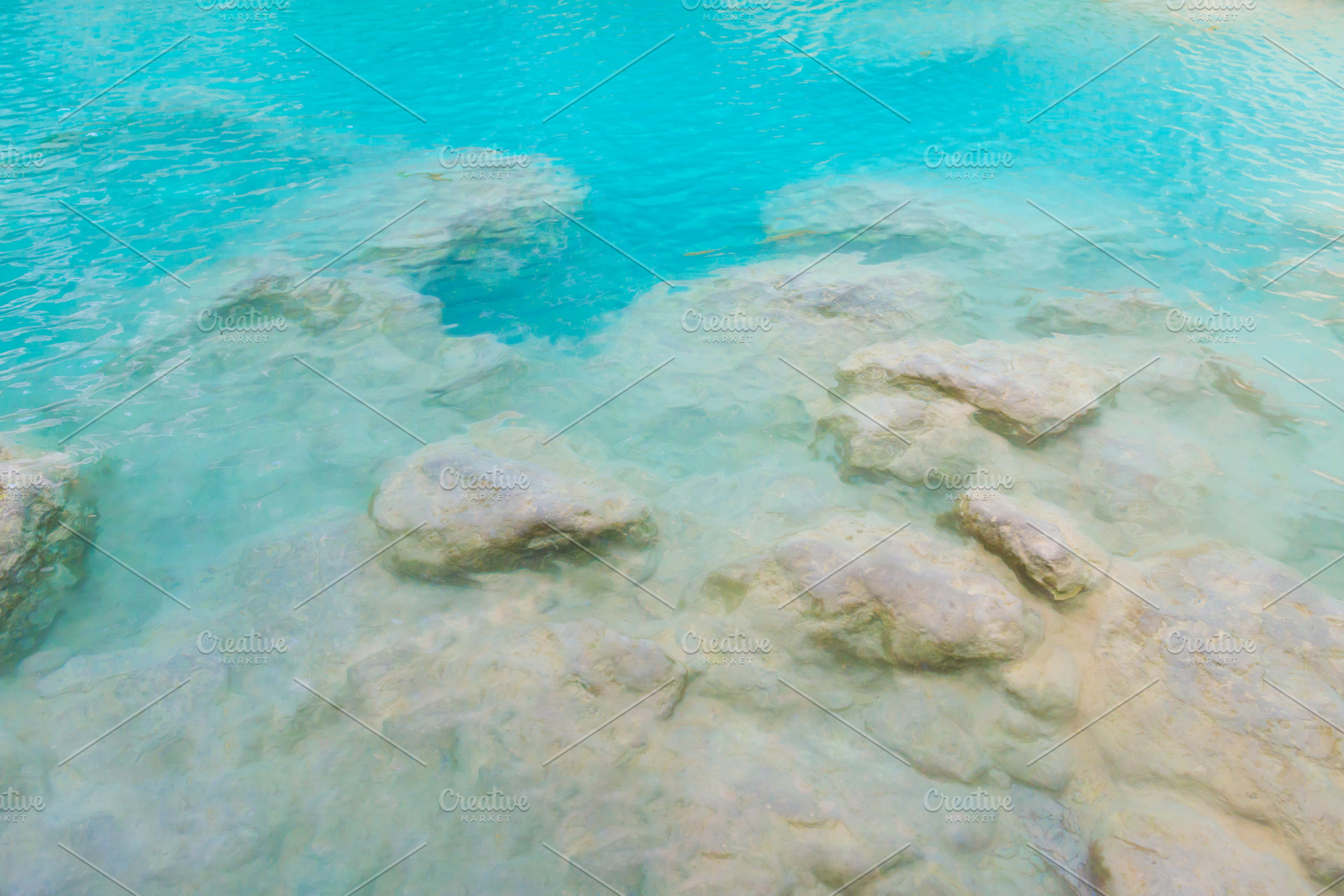 Surface of emerald blue water of tropical lake, a Nature Photo by Vapi