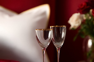 Romantic Valentine's Day setting with elegant wine glasses, a co, a Photo by Studio ANNA