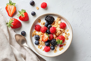 Healthy yogurt bowl with berries and granola, a Food & Drink Photo by AlyaAnd