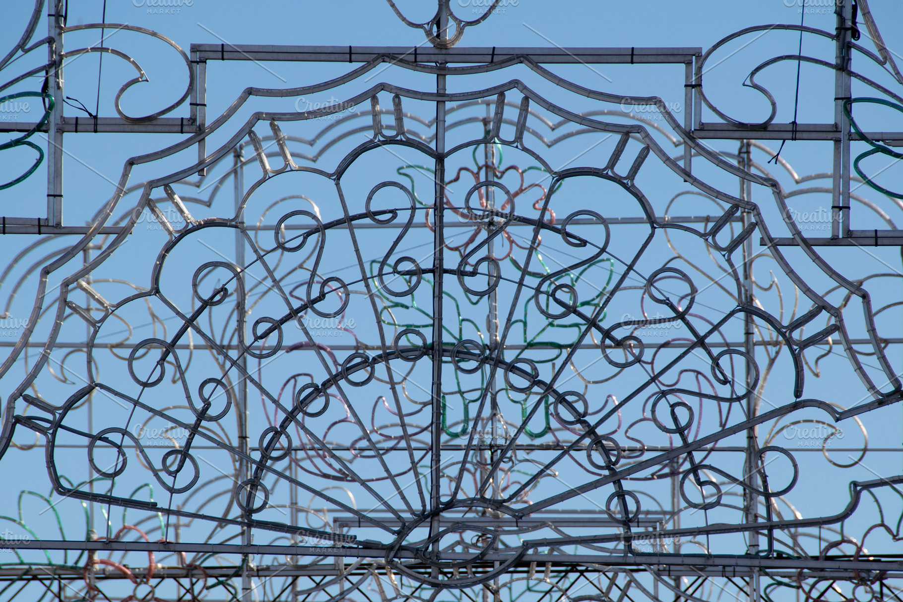 Ornamental iron gate against clear blue sky, an Architecture Photo by DanFLCreativo