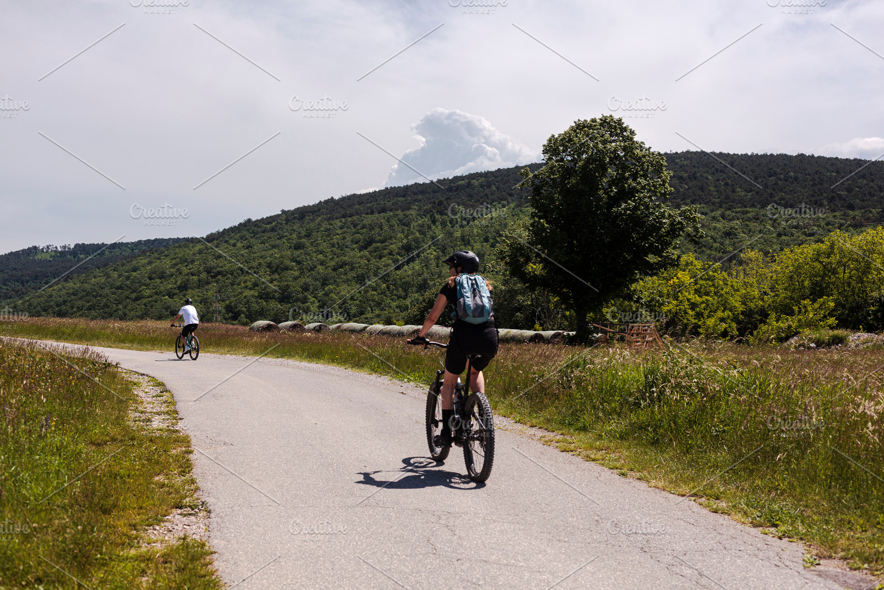 Two road cyclists, male and female on the road, a Sports & Recreation Photo by Bepslabor