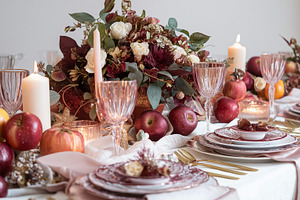 Elegant autumn tablescape with fresh apples and burning candles creating a warm, a Food & Drink Photo by Studio ANNA