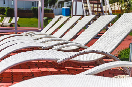 A number of many light loungers near the pool with a slide, a Sports & Recreation Photo by TanaCh