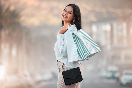 Fashion, style and shopping bags with a woman out on an urban city street enjoying a spending spree. Stylish and rich arab female customer or tourist happy after buying items on discount sale, a Photo by Peopleimages.com