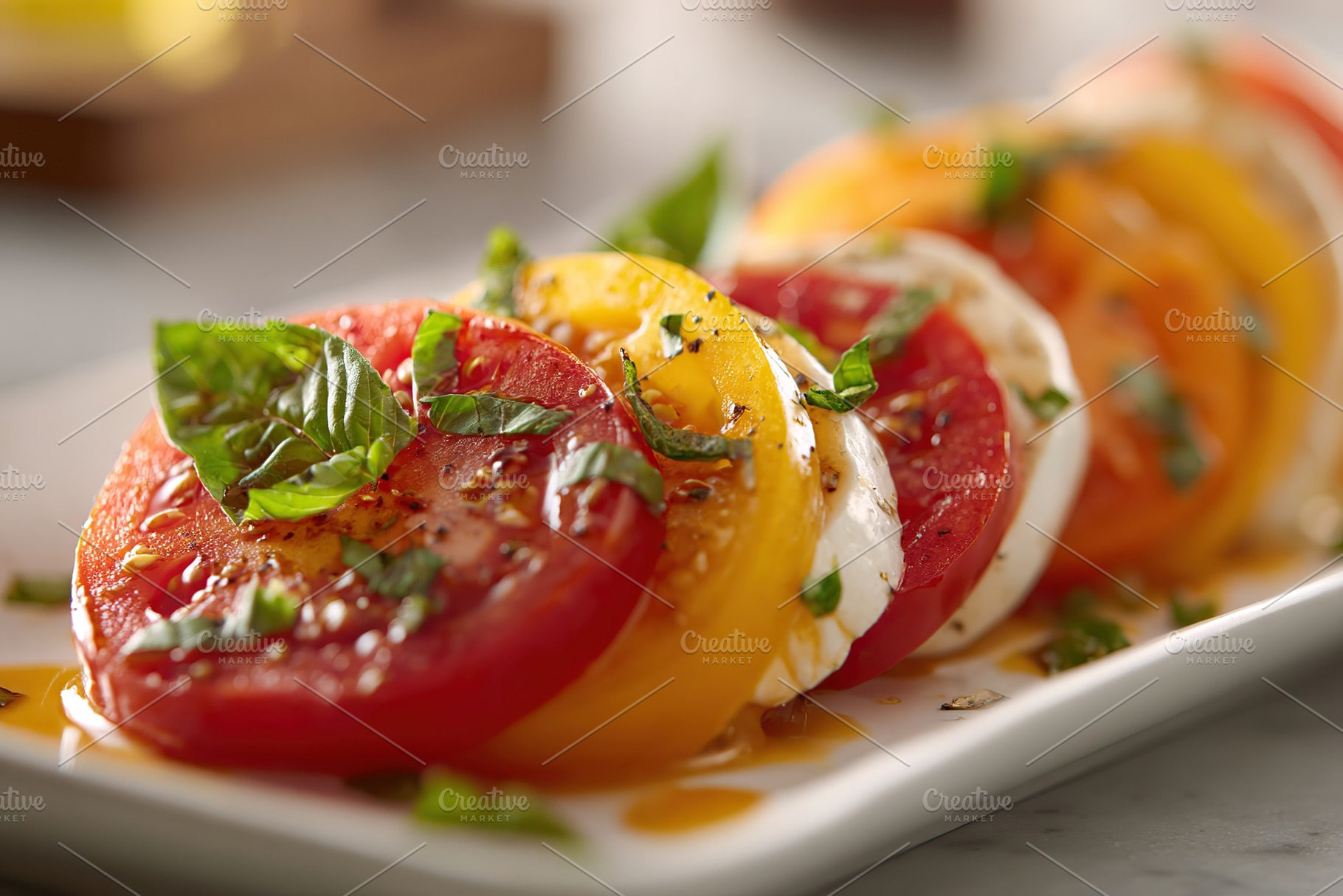 Delicious caprese salad featuring vibrant heirloom tomatoes and fresh basil dri, a Food & Drink Photo by AlyaAnd