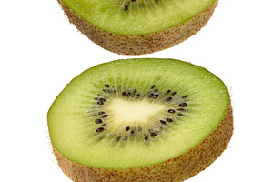 Ripe kiwi fruit cut into pieces on isolated background, a Food & Drink Photo by ndanko