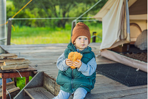 Young toddler tourist in a warm vest, a Holiday Photo by Elizaveta Galitskaya
