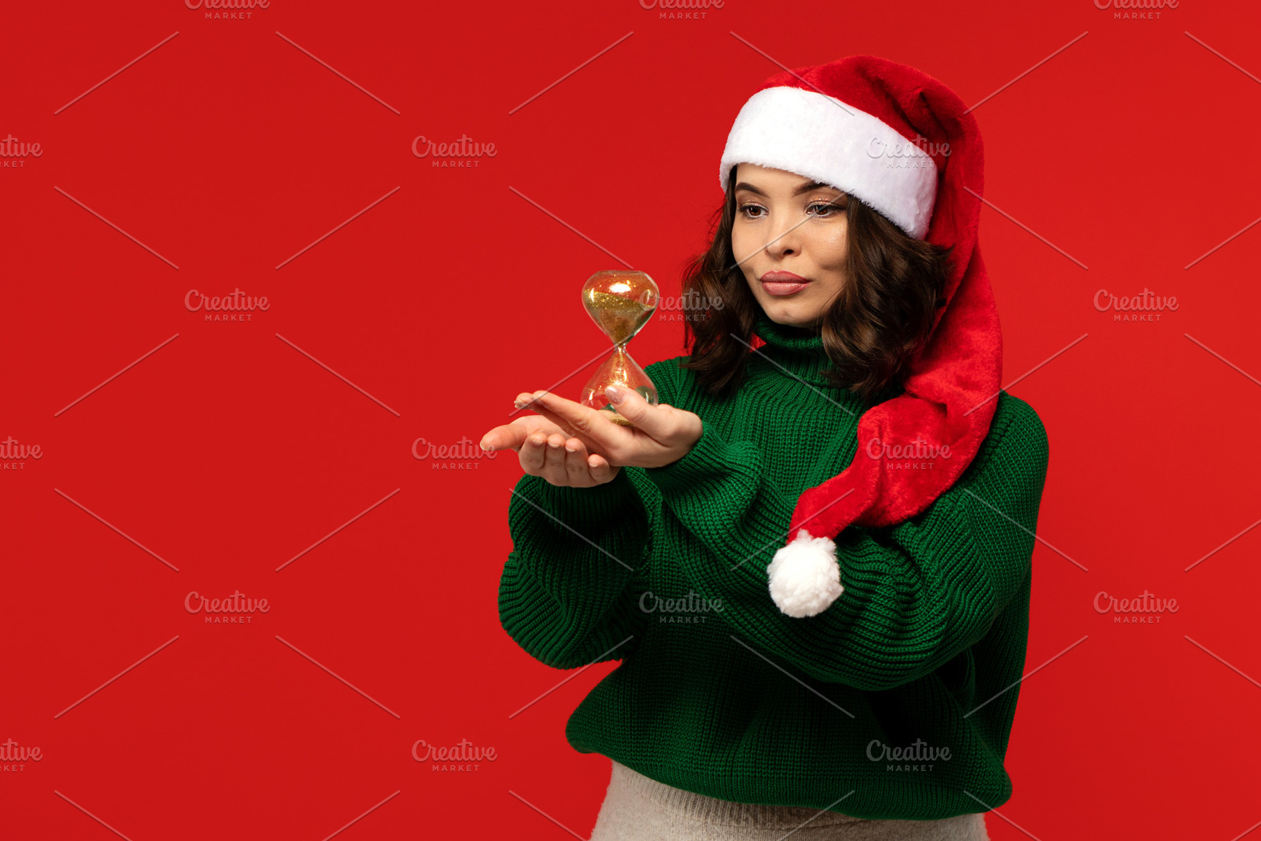 Woman in Santa hat holds golden hour, a Holiday Photo by Elena Vagengeim