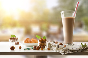 Hazelnut drink on table in a terrace with hazelnut fruits, a Food & Drink Photo by Davizro's Market