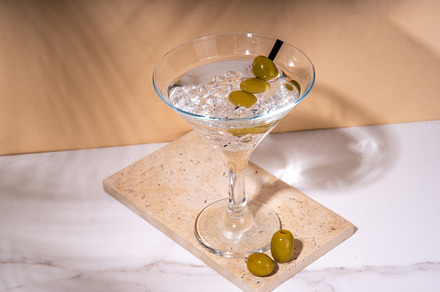 Classic martini cocktail with olive, a Food & Drink Photo by Rimma