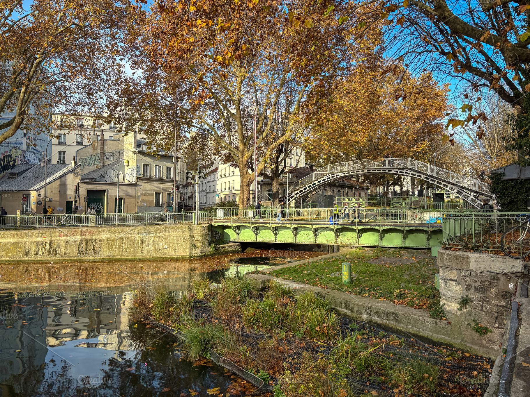 Autumn bridge view over canal Saint Martin in Paris, France, an Architecture Photo by GoodGoods