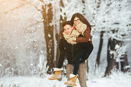 Happy couple playful together in snow park containing amazing, snow, and