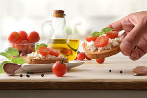 Hand Holding Tomato Ricotta Toast, a Food & Drink Photo by Davizro's Market