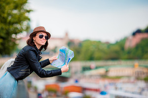 Happy young woman with a city map in europe travel tourist woman with map in