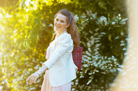 smiling elegant 40 years old woman in dress and jacket in city, a Person Photo by Alliance Images