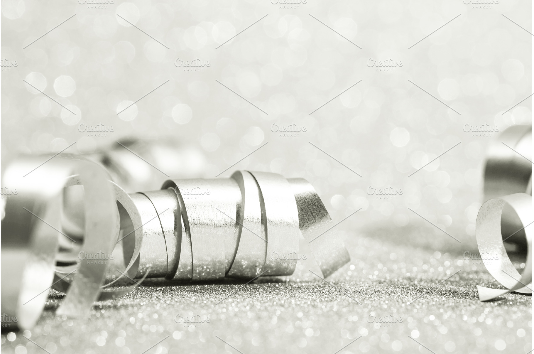 Silver curling ribbons creating, a Holiday Photo by Anna Efetova