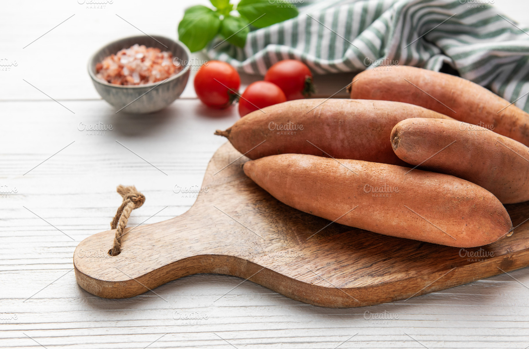 Sweet potatoes on cutting board with tomatoes and basil, a Food & Drink Photo by Olena Rudo