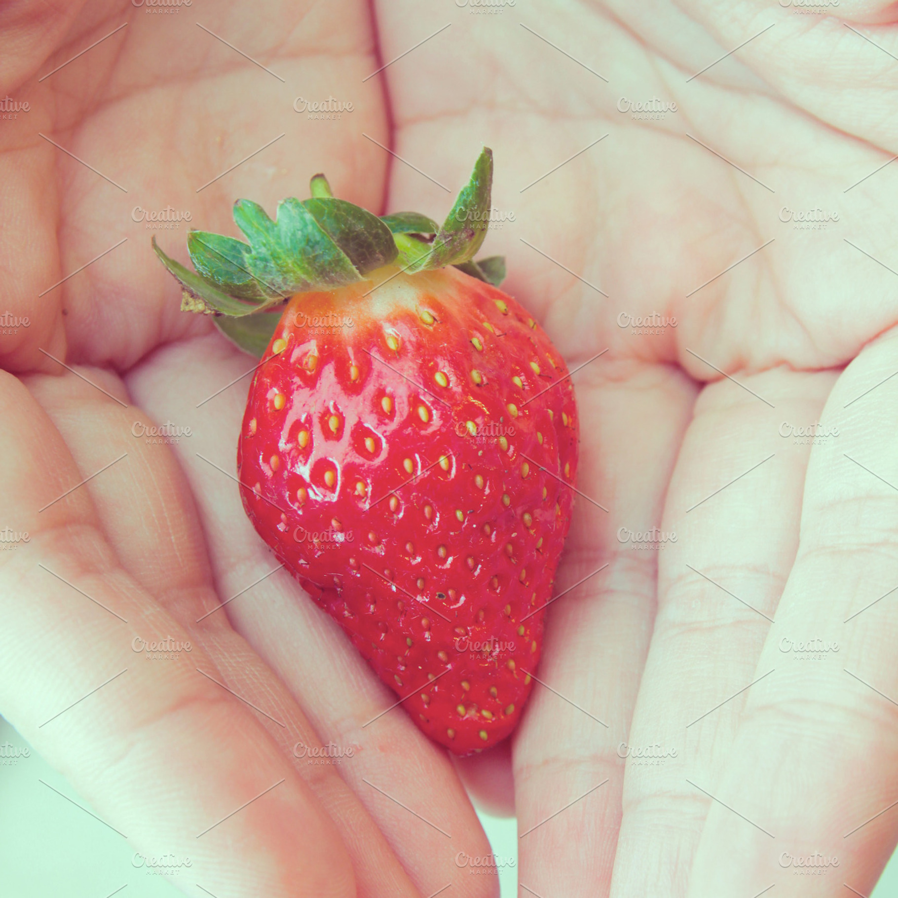 Strawberry in hand featuring strawberry, hand, and fruit