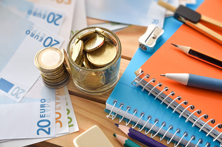 Concept cost of school supplies with material and money