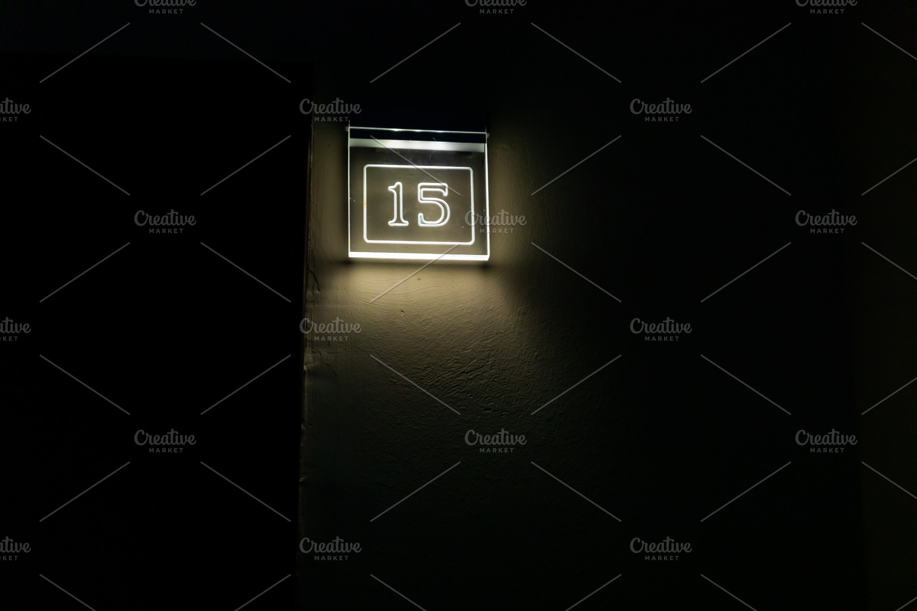 Glowing number 15 lightbox mounted on a dark wall, minimal modern style, perfec, an Abstract Photo by Ales Munt