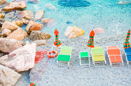 Sunbeds and umbrellas at beautiful european seashore in monterosso cinque, a Nature Photo by travnikovstudio