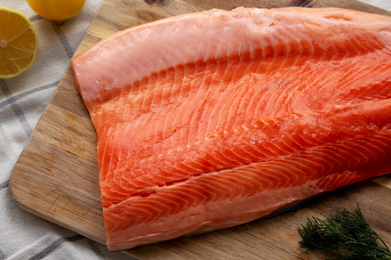 Organic Raw Salmon Fillet on a wooden board, top view. Flat lay,, a Food & Drink Photo by LiudmylaChuhunova
