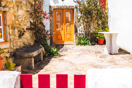 Rustic house with red gate