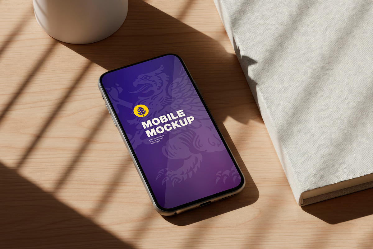 Mobile Mockup on Desk, a Product Mockup by OneVectorStock (Photo 1 of 2)