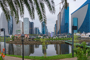 Modern skyscrapers skyline reflected in lake water with palm tre, a Photo by Pictures for you!!!!!!!!!
